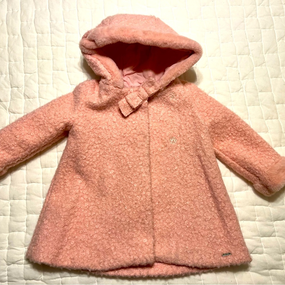 Pink winter coat by Mayoral.  Furry hooded jacket is a size 36 months in pink.